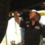 Mechanic Ryan workging on a car clutch on the hydraulic lift